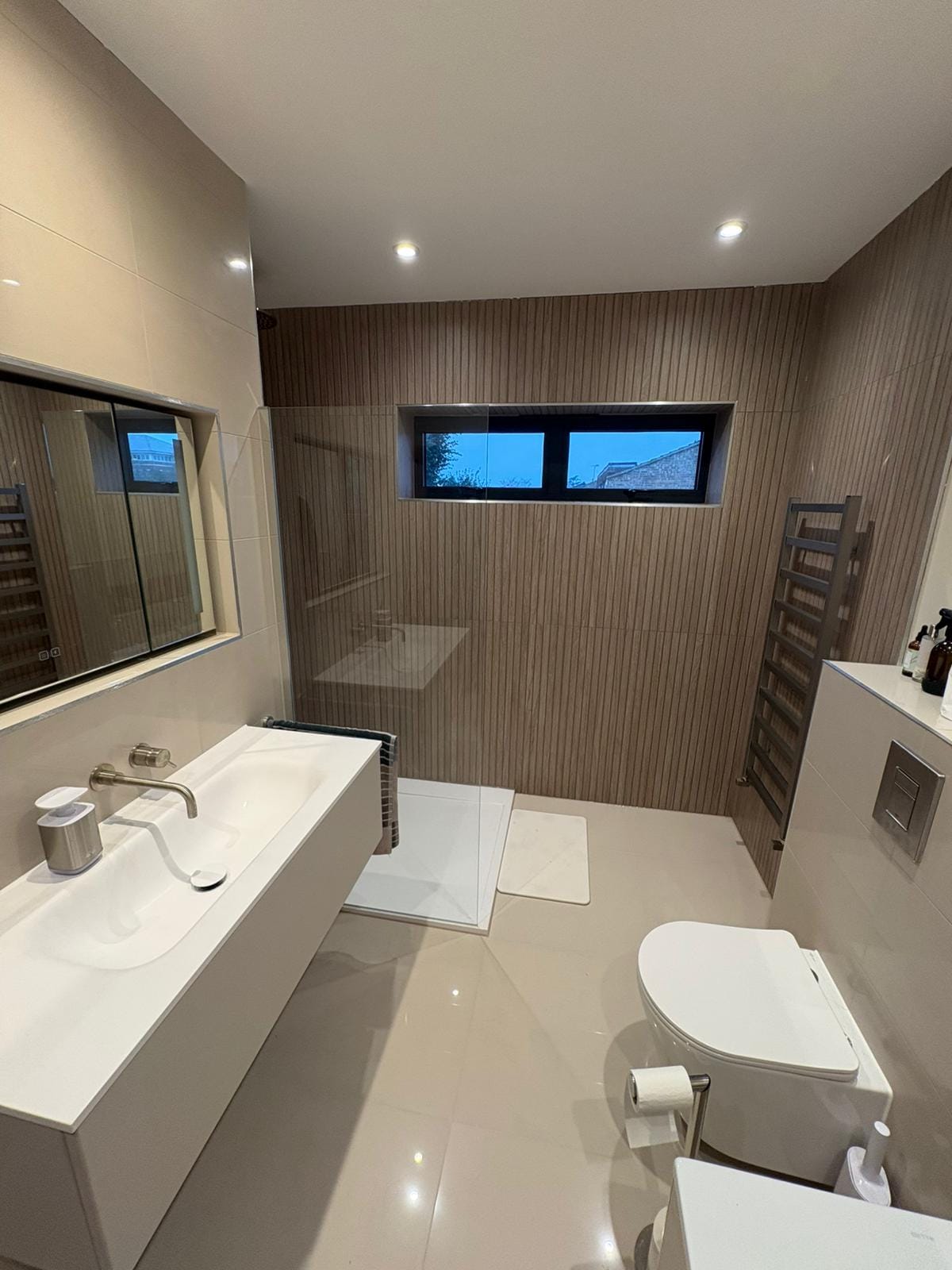 Neutral spa-style bathroom with large format tiles
