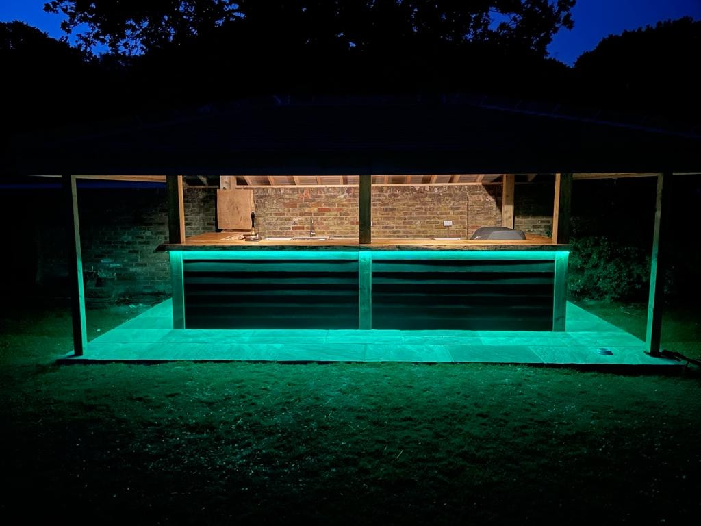 Outdoor bar lit at night with LED strip lighting