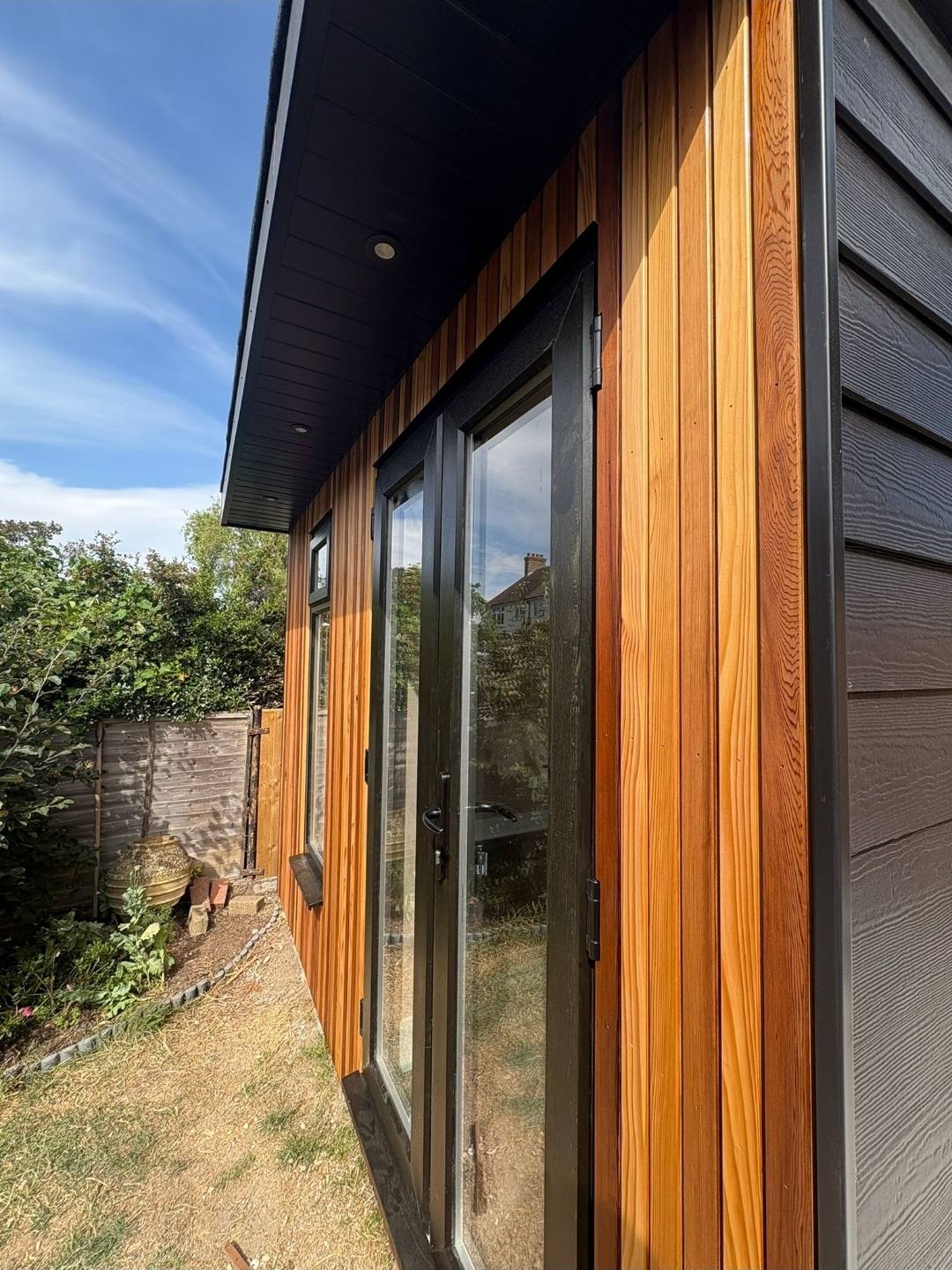 Cedar cladding and glazed door close-up