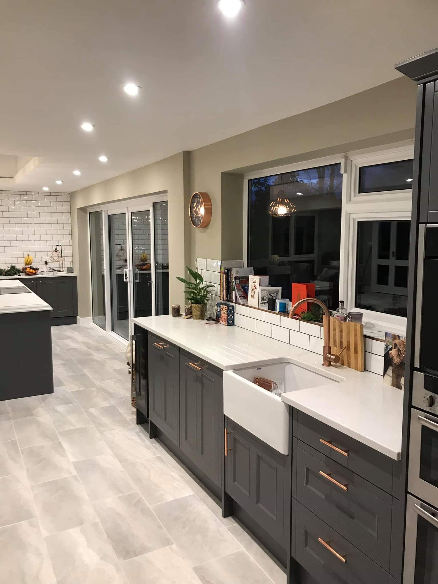 Dark shaker kitchen with Belfast sink and copper fittings