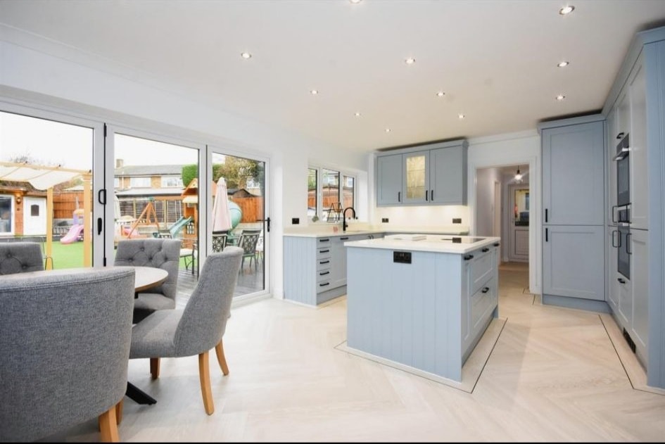 Light blue shaker kitchen with bifold doors