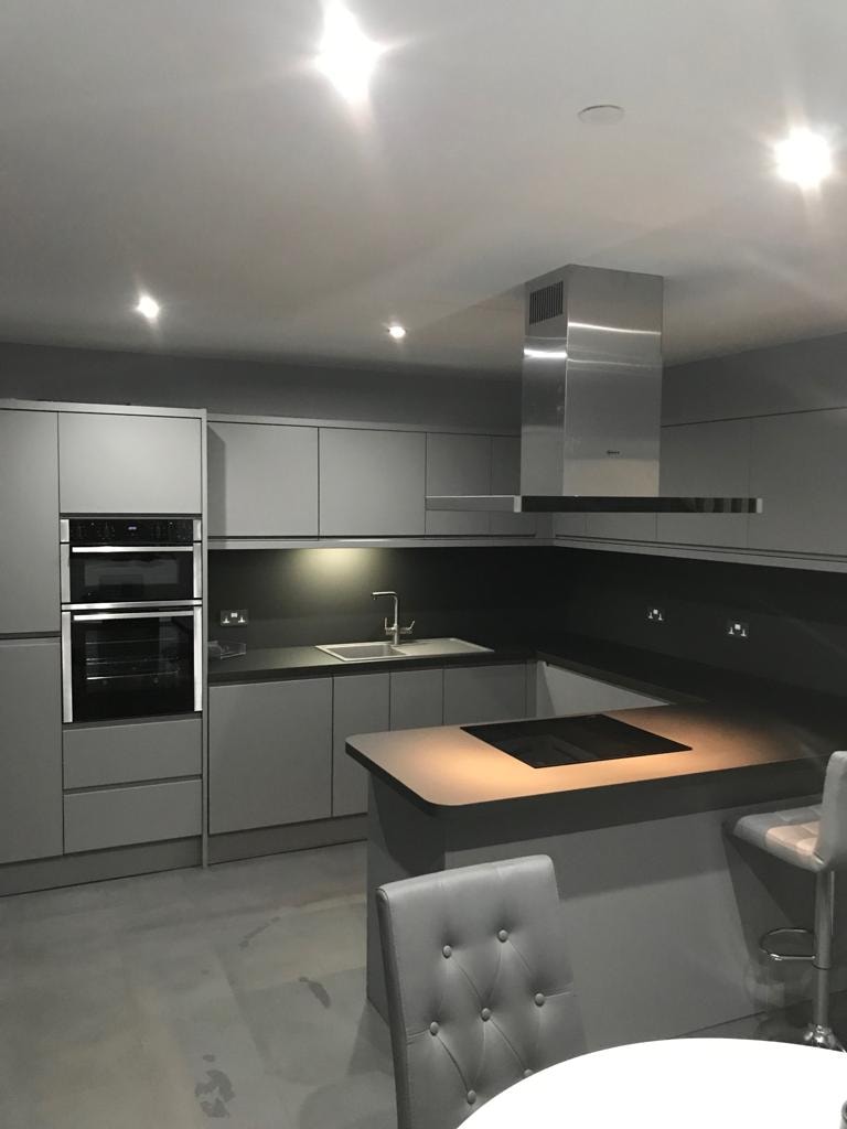 Sleek grey handleless kitchen with island