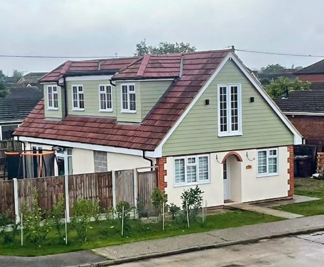 Completed loft conversion with sage cladding and dormers